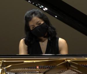 masked woman playing piano