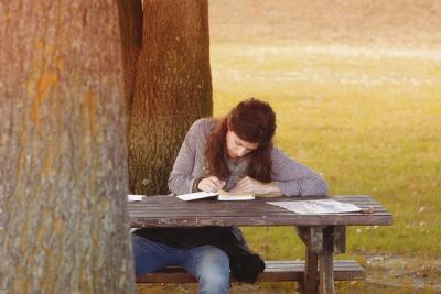 Decorative - a girls studying near a tree