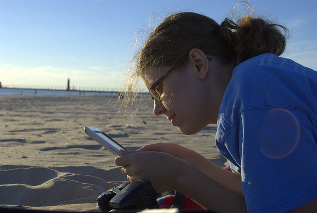 woman reading on beach